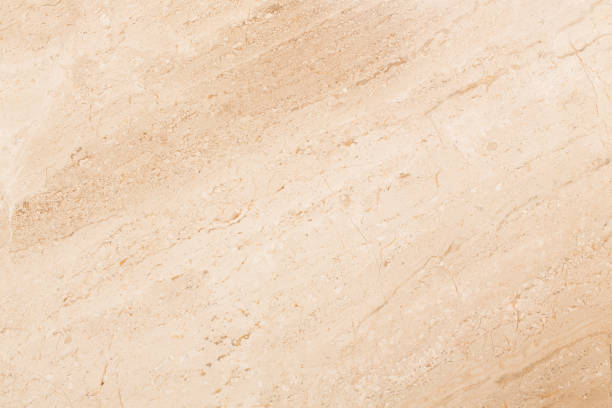 istock Light beige travertine patterned texture background. Natural light beige stone close up. 1065494996