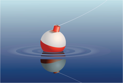 A single fishing bobber floating in a lake or pond.