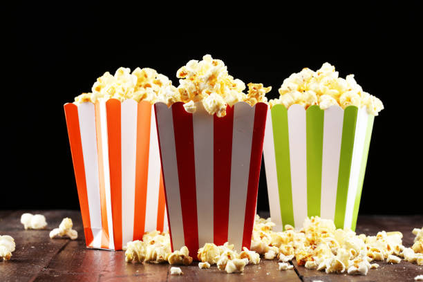 istock Cinema concept with popcorn in green white bag. 1065498422