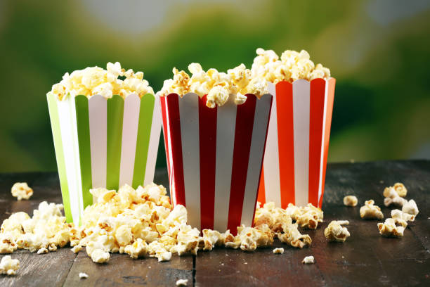 istock Cinema concept with popcorn in green white bag. 1065498626