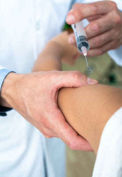 istock Doctor using syringe to give in jection to patient 1065499394
