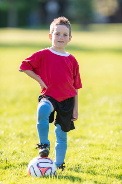 istock Boy poses proudly with soccer ball 1065504452
