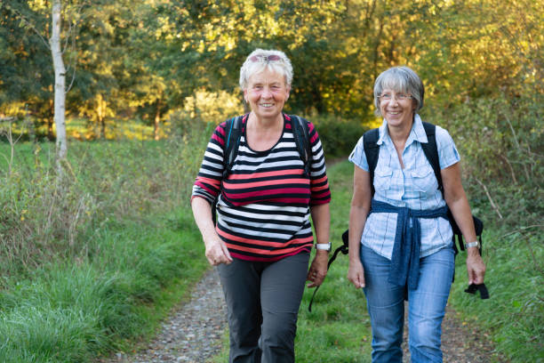 istock hiking senior women having a break drinking water 1065506204