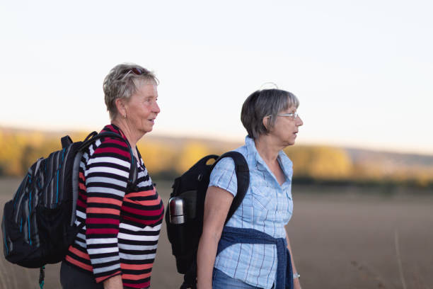 istock hiking senior women having a break drinking water 1065506400