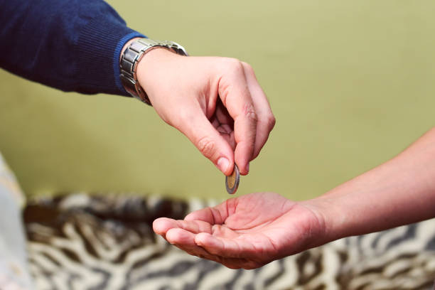 istock Hand gives money to a poor man 1065506540