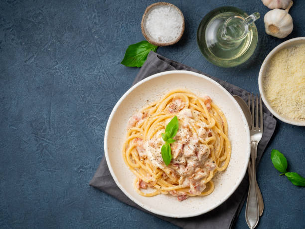 istock Carbonara pasta. Spaghetti with pancetta, egg, parmesan cheese and cream sauce. Traditional italian cuisine. Top view, copy space 1065506592