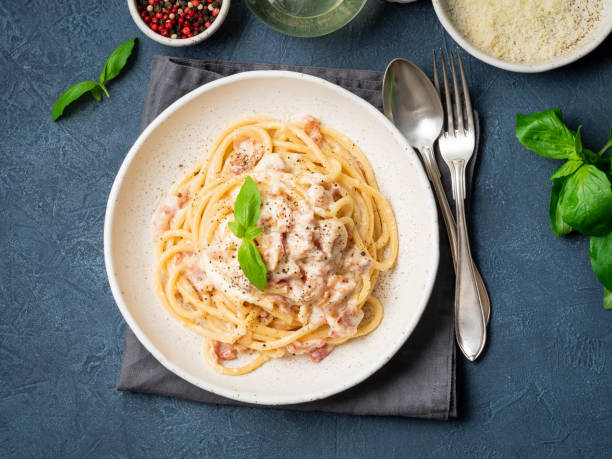 istock Carbonara pasta. Spaghetti with pancetta, egg, parmesan cheese and cream sauce. Traditional italian cuisine. Top view 1065506852