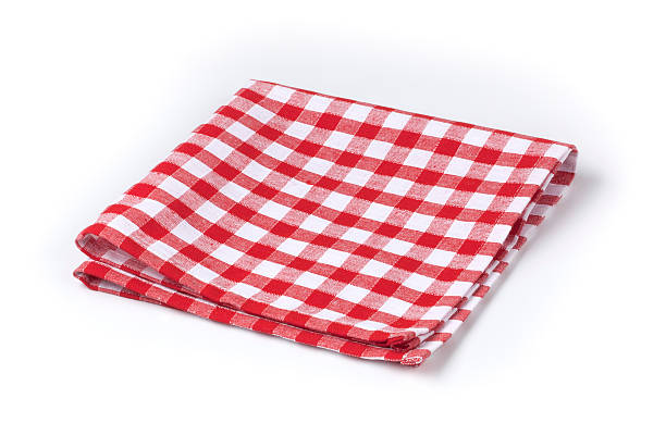 Red and white gingham tea towel on white background stock photo