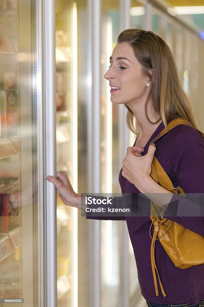 Woman in supermarket freezer section  Buying Stock Photo