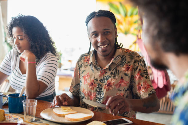 istock Young people talking and eating at breakfast 1065524276