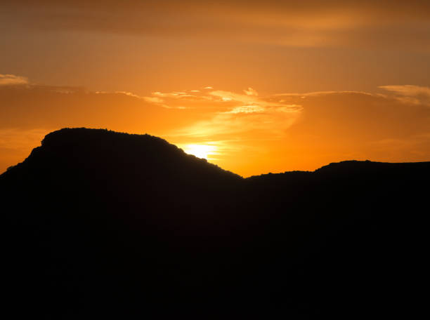 istock Sunset behind the silhouette of a mountain 1065531850