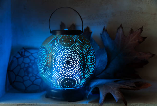 Aroma diffuser in the style of an ancient oriental lamp. Still life with a diffuser, a catcher of dreams and maple leaves.