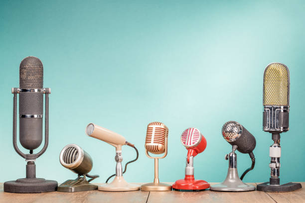 retro old microphones for press conference or interview on wooden desk front gradient mint green background. vintage style filtered photo - 1960s style 1950s style record retro revival imagens e fotografias de stock