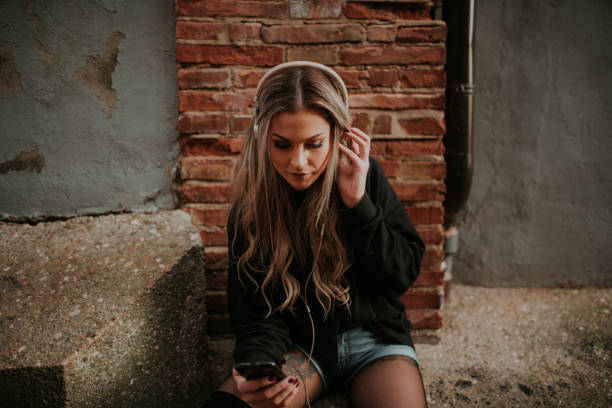 istock Young woman sitting with headphones 1065544146