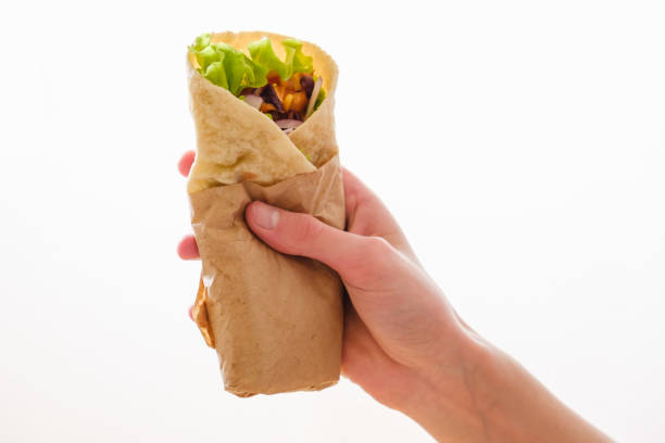 istock Mexican burrito in hand with chicken, pepper and beans 1065545436