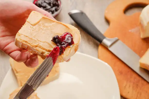 peanut butter sandwich with jam. Cutting board, Kitchen knife.