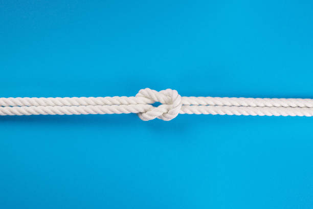 istock White ship ropes connected by reef knot on blue 1065548390