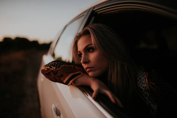 istock Young woman  on car window 1065548942