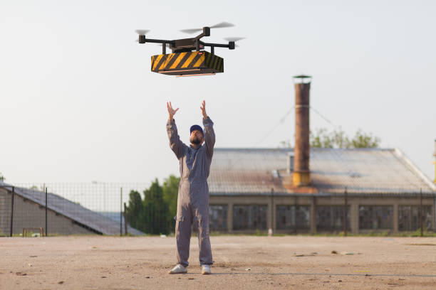 drone delivers containers to operator stock photo