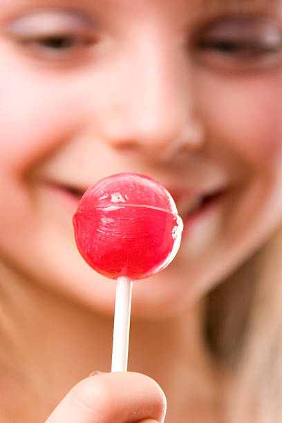 istock Beautiful young girl with lollipop red candy 106555393