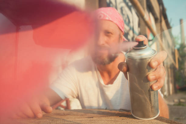 istock young man spray paint artist 1065554046