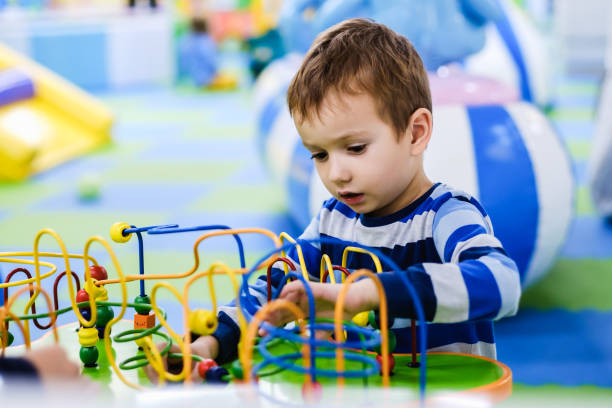 istock Child boy. Elementary age kids, table board game, children's education and entertainment. 1065555880