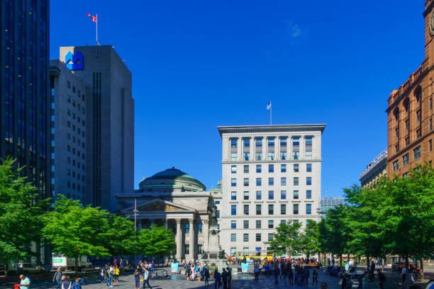 Place dArmes square, in Montreal Montreal, Canada - September 08, 2018: Scene of Place dArmes square, with locals and visitors, in Montreal, Quebec, Canada place darmes montreal stock pictures, royalty-free photos & images