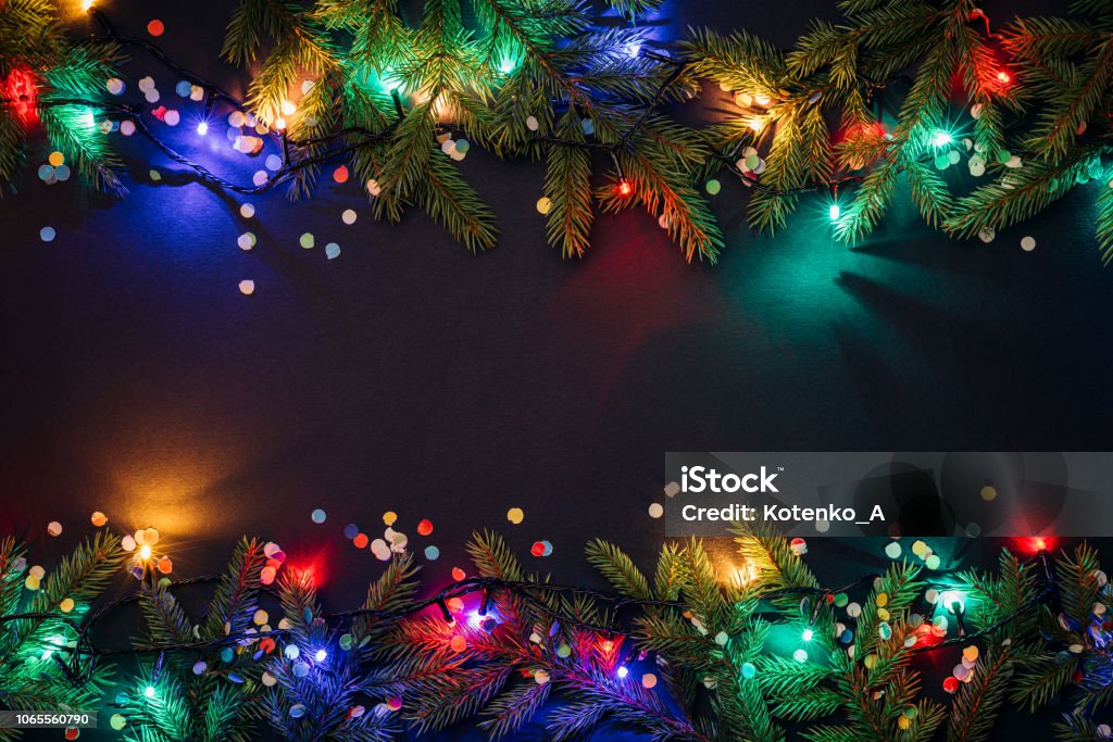 Merry christmas and happy new year background Christmas and New Year background with copy space for text. Fairy lights and decor of fir branches and confetti. Flat lay, top view Christmas Lights Stock Photo