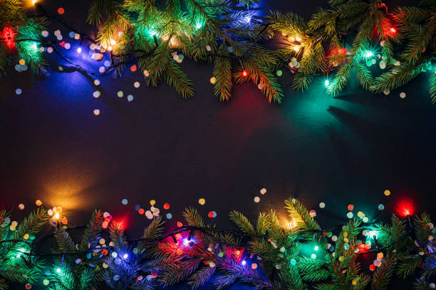 Merry christmas and happy new year background Christmas and New Year background with copy space for text. Fairy lights and decor of fir branches and confetti. Flat lay, top view fairy lights stock pictures, royalty-free photos & images