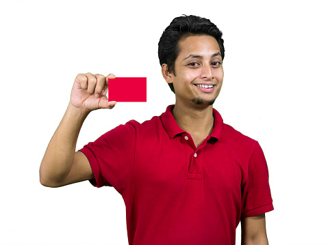 Young man pointing his card in hand. Isolated on white.