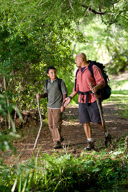 istock Hispanic father and son hiking on trail in woods 106556993