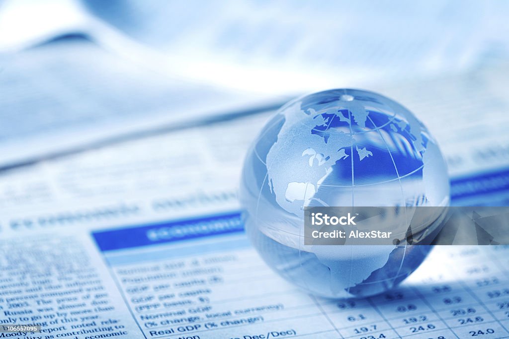 Glass globe Glass globe on newspaper Business Stock Photo