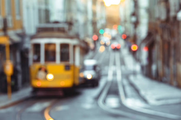 Travel blurred backgrounds : Yellow tram of the Route 28 on the street of Lisbon. It is one of the most popular routes by tourists.