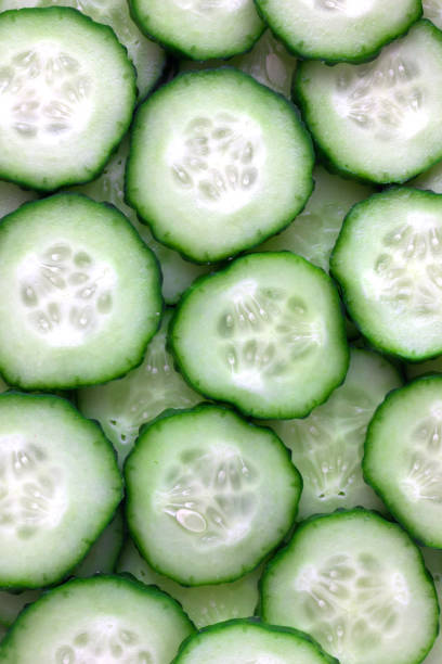 istock Fresh green cucumbers sliced. Several sliced cucumbers stacked on top of each other. 1065583152