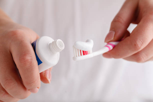 istock toothpaste extruded from tube on toothbrush close up 1065585862