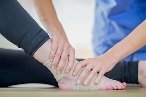 istock Physiotherapist treats an ankle injury 1065600156