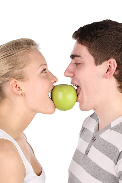 istock girl and  young man bite together green apple 106560194
