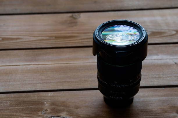 istock Camera lens on a wooden table 1065603598