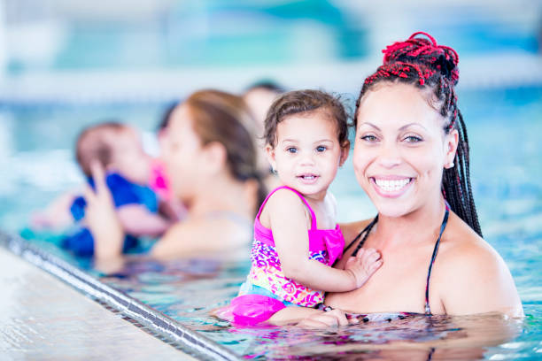 istock A mother and daughter pose for a picture in a pool 1065608656