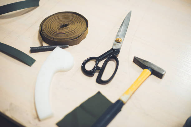 istock close up view of working table with fabric, hammer and scissors at workshop 1065627810