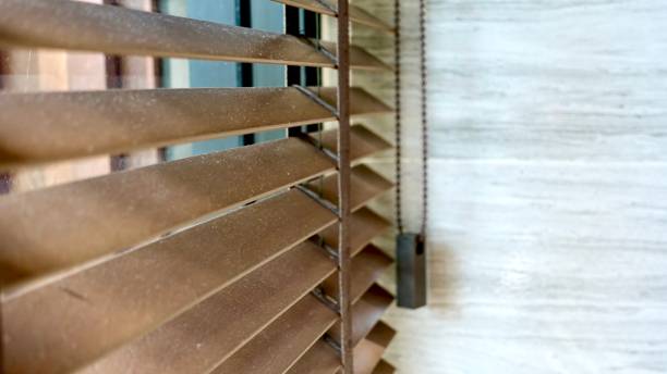istock Evening sun light outside wooden window blinds, sunshine and shadow on window blind and Granite tile wall 1065629854