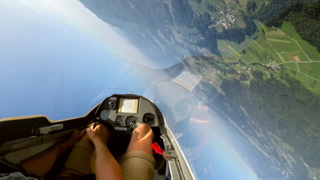 SPEED UP POV: Pilot controlling the glider and doing loops in the sunny sky