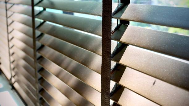 istock Evening sun light outside wooden window blinds, sunshine and shadow on window blind and Granite tile wall 1065630016