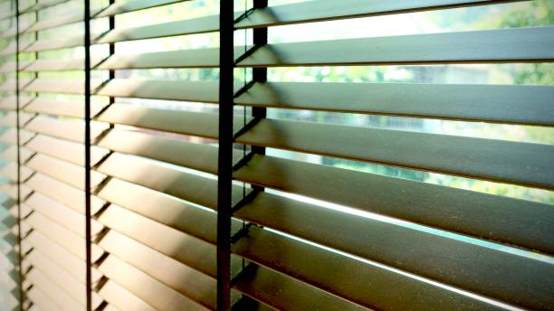 istock Evening sun light outside wooden window blinds, sunshine and shadow on window blind and Granite tile wall 1065630184