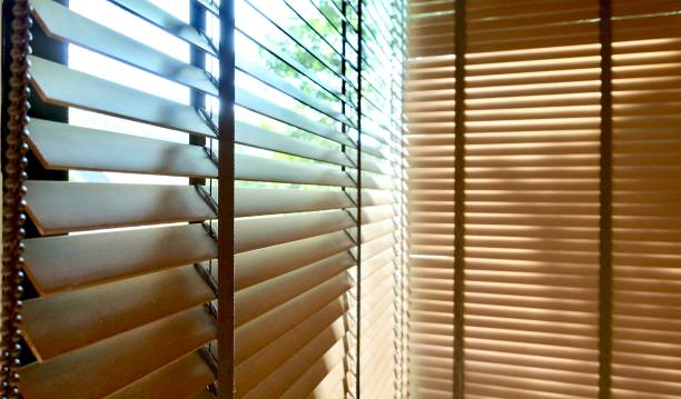 istock Evening sun light outside wooden window blinds, sunshine and shadow on window blind and Granite tile wall, decorative interior home 1065630564