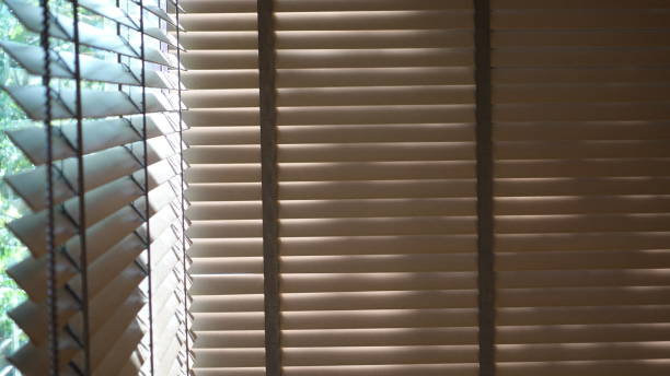 istock Evening sun light outside wooden window blinds, sunshine and shadow on window blind and Granite tile wall 1065630788