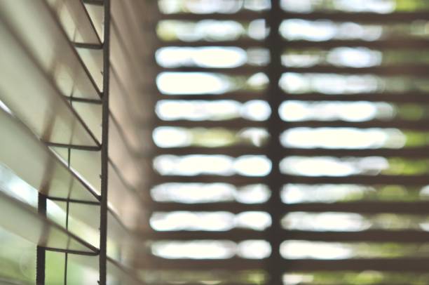 istock Evening sun light outside wooden window blinds, sunshine and shadow on window blind and Granite tile wall 1065633236
