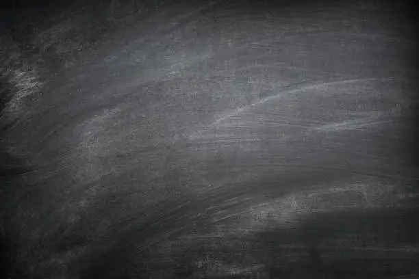 Photo of Blank black chalkboard with chalk traces