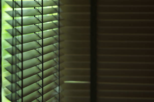 istock Evening sun light outside wooden window blinds, sunshine and shadow on window blind and Granite tile wall 1065637438
