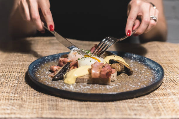 istock Woman in restaurant eating eggs 1065644594